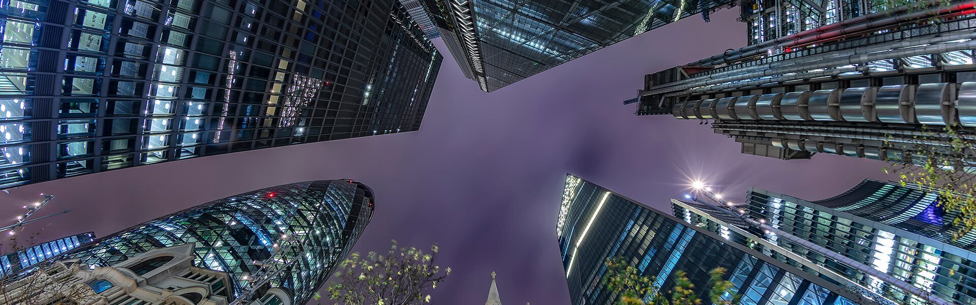 Looking up at high rise buildings in London at night